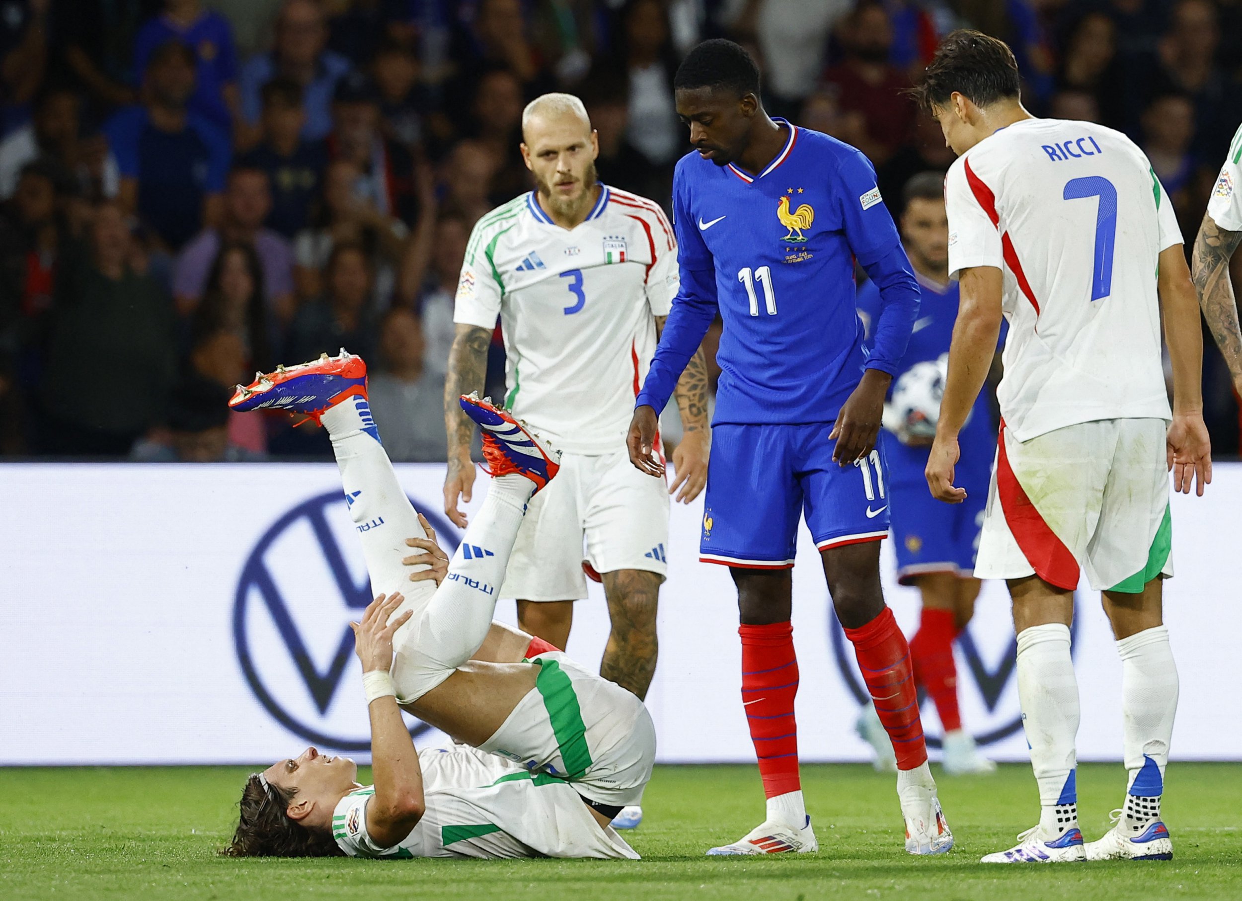 Italy's Riccardo Calafiori reacts after sustaining an injury in Italy's win over France