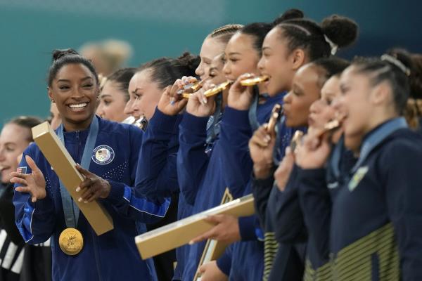 Simone Biles and her US team celebrate after winning gold in Paris.